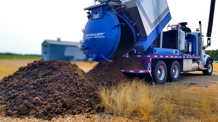 photo of an airvac truck dumping fresh dirt excavated from a project site in Alberta